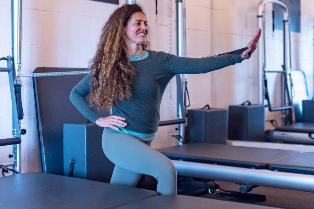 Catherine is known for yoga, personal training and Reformer Pilates. Here she performs an exercise at NOAHBOA Pilates club.